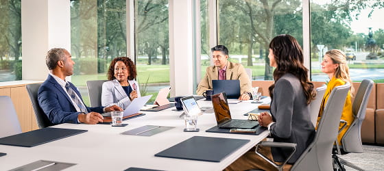 Experience professionals meeting in glass boardroom