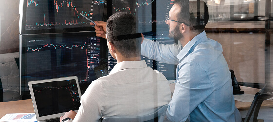 Two trader checking cryptocurrency information data on special graph
