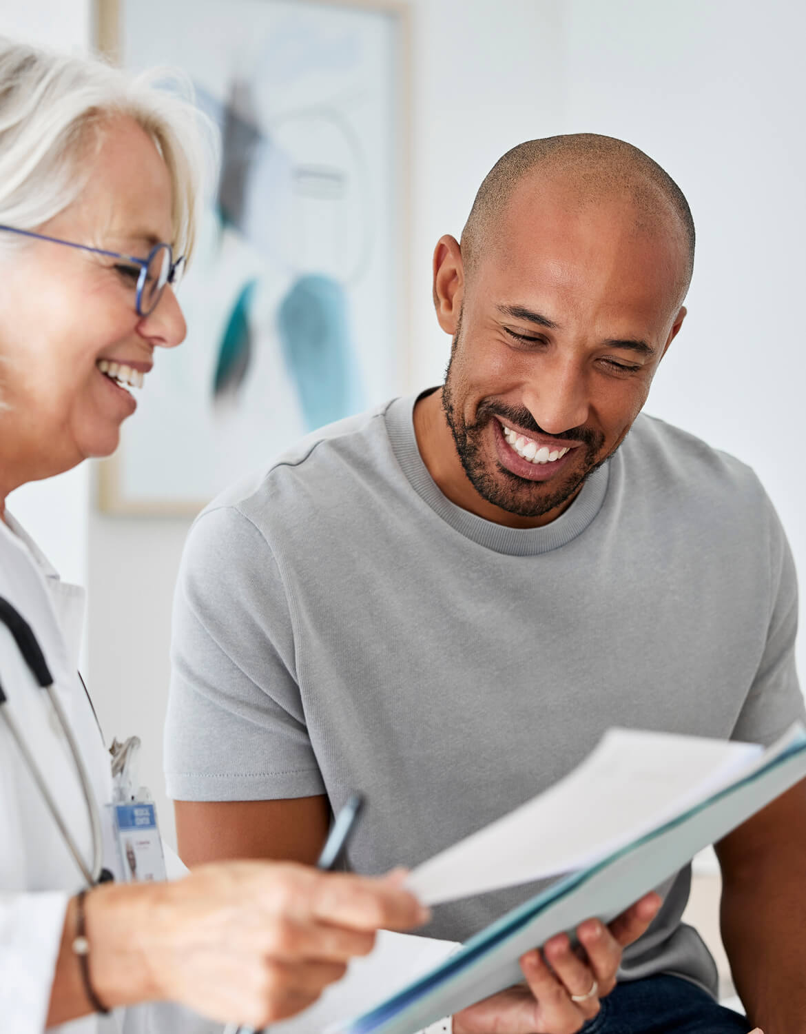 Doctor and patient reading test results at clinic